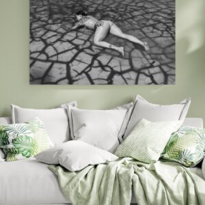 Black and white boudoir image in pond with cracks in the mud